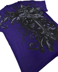A purple short-sleeve graphic t-shirt featuring a large black and gray gothic-style print with a skull, ornate scrollwork, and a banner reading 'AMESCENSE'.
