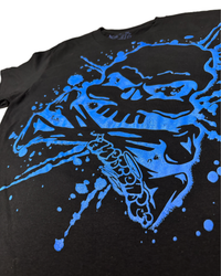 A close-up of a black t-shirt featuring a large, vibrant blue graphic print of a skull with crossed bones and the word 'MURDER' stylized on the front.